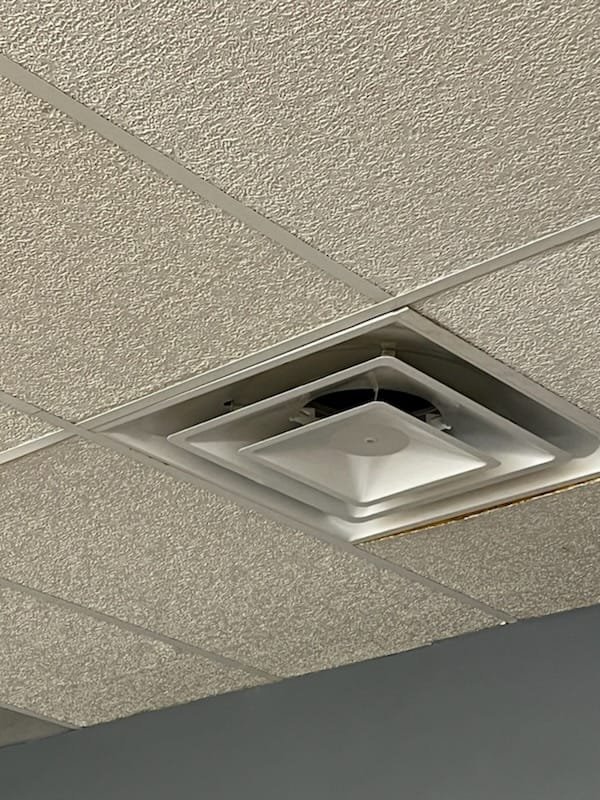 Ceiling air diffuser in a commercial interior